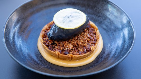 Cretan nut tart with lemon ouzo curd, licorice ice-cream and glazed lemon.