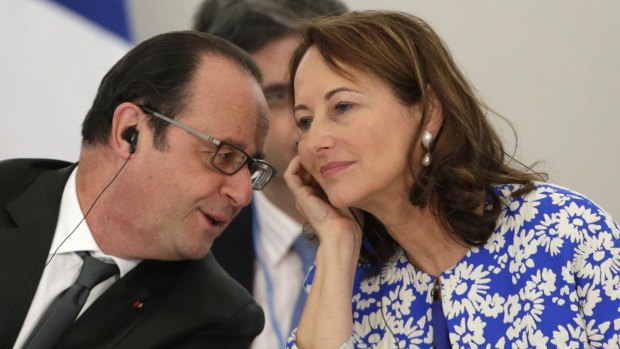 French President Francois Hollande, left, speaks with former wife and current French Minister for Ecology, Sustainable Development and Energy Segolene Royal at the climate summit.