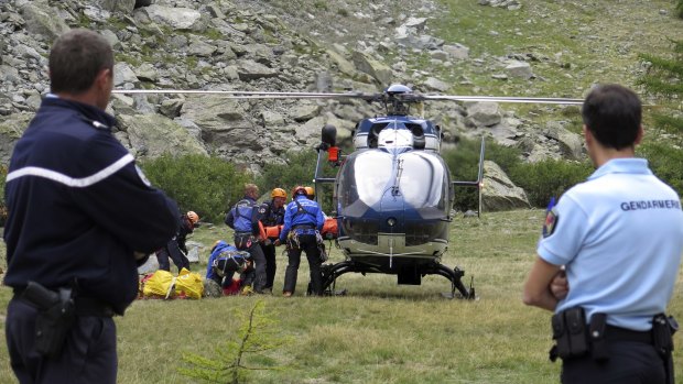 French rescue workers load a victim into n helicopter after an avalanche near Pelvoux, French Alps, on Tuesday. 