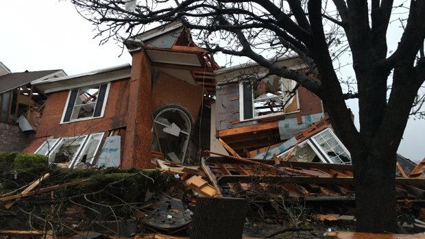 A damaged house after Saturday's tornado spread out in Rowlett, Texas.