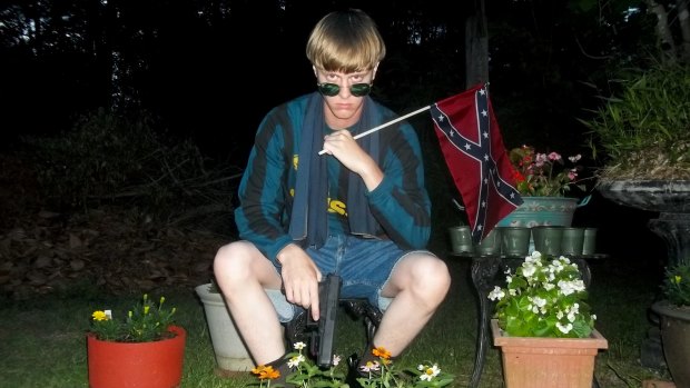 This image that appeared on Lastrhodesian.com, a website being investigated by the FBI in connection with the Charleston shooting, shows suspect Dylann Roof posing with a gun and a Confederate flag. 