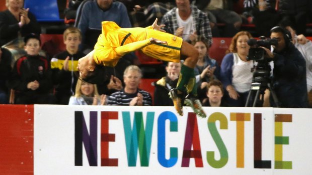 Australia's Sam Kerr does a backflip to celebrate scoring against Brazil.