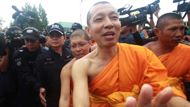 Monks protest against the attempted arrest of 72-year-old monk Phra Dhammajayo, the temple’s former abbot.