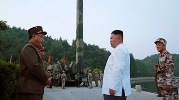North Korean leader Kim Jong-un and a missile launcher in North Korea.