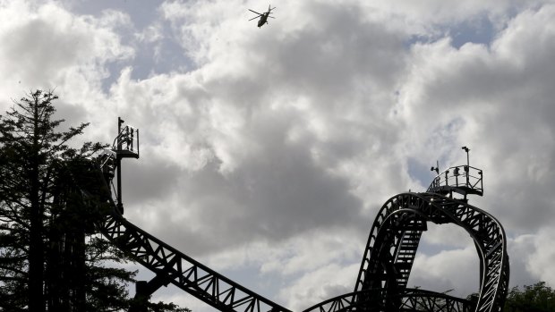 An air ambulance flies over The Smiler at Alton Towers in Alton, Britain where 16 were injured.