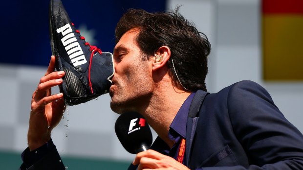 Webber drinks champagne from the boot of Daniel Ricciardo after the Belgium GP.