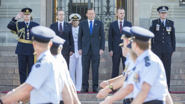 [L-R]: Chief of the Defence Force, Air Chief Marshal Mark Binskin, salutes as Opposition Leader Bill Shorten, Prime Minister Tony Abbott, ACT Chief Minister Andrew Barr and Australian Federal Police Commissioner Mark Colvin receive the parade on Saturday. 

