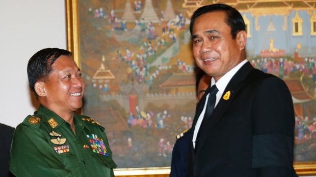 Generals: Myanmar's Min Aung Hlaing, left, shakes hands with Thai PM Prayuth Chan-ocha in Bangkok in August.