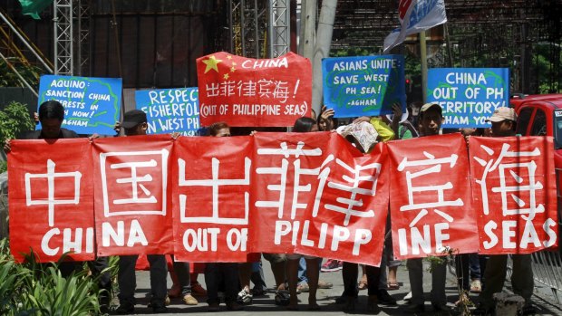 Environmental activists march in Manila in May to demand that Chinese authorities put a stop to reclamation activities in the South China Sea.