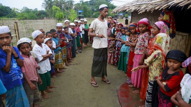 A Rohingya Muslim religious teacher conducts a Koran class for children at a refugee camp outside Sittwe, Myanmar, on Thursday.