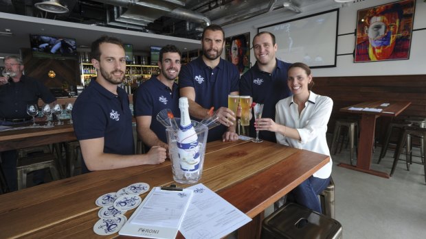 Business partners and Brumbies teammates, Scott Fardy, third from left, and Ben Alexander, fourth from left, with other The Dock bar at Kingston Foreshore partners (from left) Brendan Curtis-Cocks, Glen Collins and Jane Collins. 