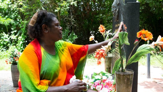 Eddie Mabo's daughter, Celuia Mabo, who lives in Brisbane, becomes emotional at the grave of her father.