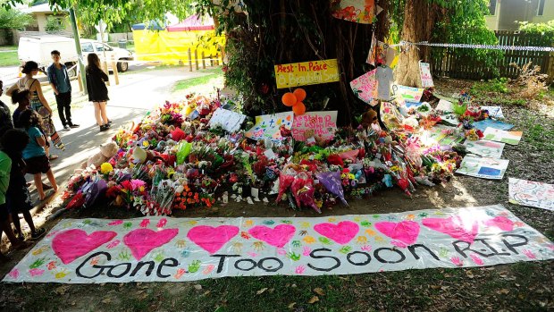 A  memorial of flowers, toys and candles in a park next to the home where the multiple stabbing occurred in Cairns.