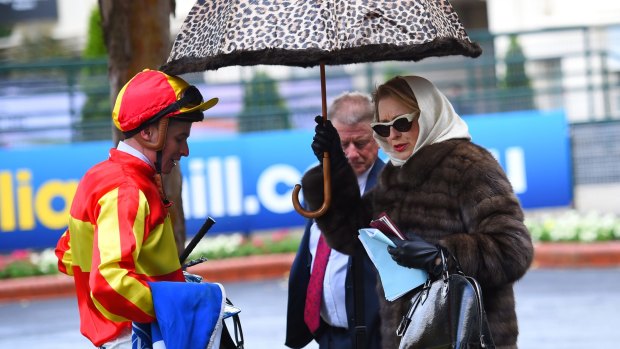 Trainer Gai Waterhouse keeping dry after Race 1 during Cox Plate Day at Moonee Valley Racecourse.