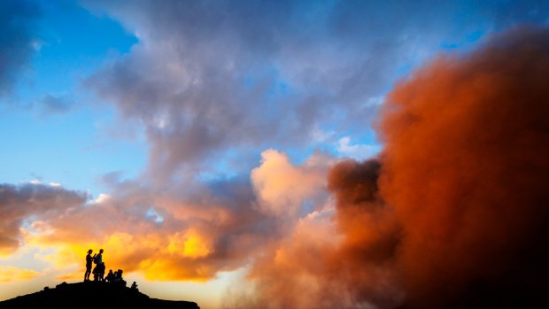 Silhouettes of tourists watching eruptions in the crater of the active Mt Yasur Volcano on Tanna Island, Tafea, Vanuatu. 