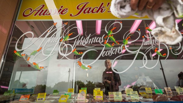 Passionate about his work: Robbie Holbery perfects his copperplate Christmas message on Aussie Jack's butchers in Watsonia.