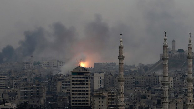 Fire rises following a Syrian government air strike that hit rebel positions in eastern Aleppo on Monday.