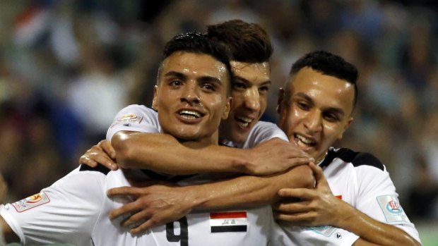 Ahmed Yasin celebrates a goal for Iraq against Palestine in the group stage.