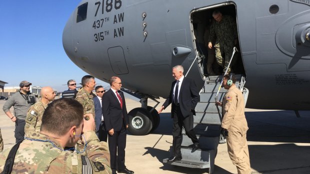 US Secretary of Defence Jim Mattis, second from right, is greeted by US Ambassador Douglas Silliman as he arrives at Baghdad International Airport, Iraq, on Monday.