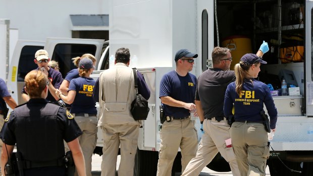 US federal agents and Key West Police gather in a parking lot after a man described by the FBI as an Islamic State sympathiser was charged with plotting to detonate a nail-filled backpack bomb on a Florida beach. 
