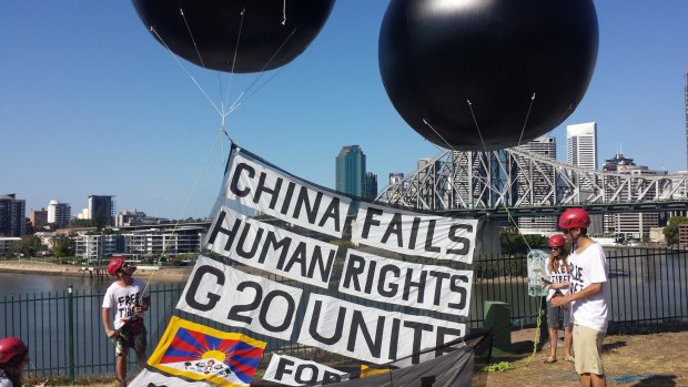 Activists from the Australian Tibet Council release two huge balloons in New Farm, Brisbane.