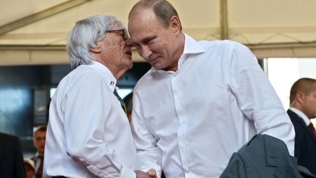 Stage managed: Formula One boss Bernie Ecclestone greets Putin.