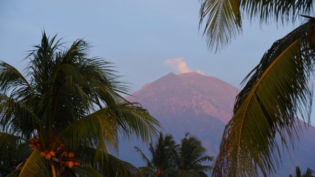 Steam rises from Mount Agung which has been threatening threatening to erupt for a week.