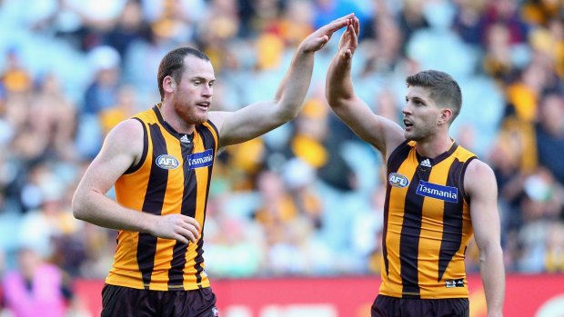 Forward march: Jarryd Roughead is congratulated by Hawks teammate Luke Breust after kicking a goal against the Melbourne Demons at the Melbourne Cricket Ground last Saturday.