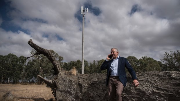 Telstra chief executive Andrew Penn next to the 100th base station built under the government's Mobile Black Spots Program.  