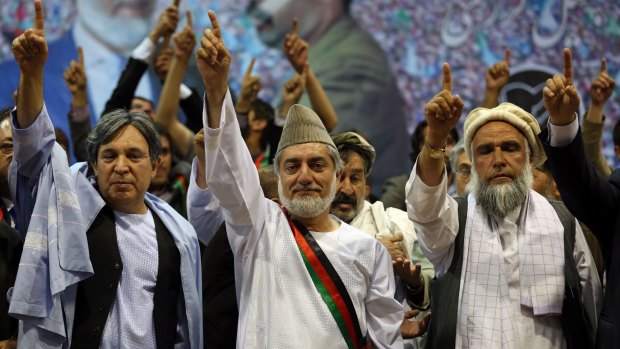 Then presidential candidate Abdullah Abdullah, centre, is now the country's "chief executive", second only to the president. 