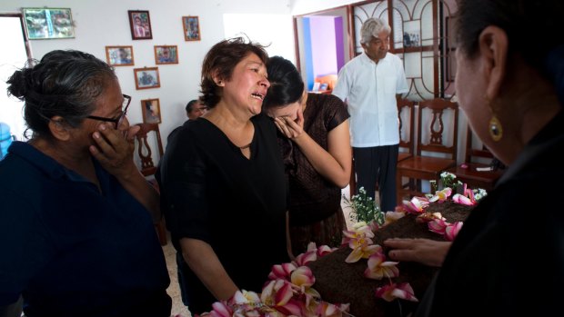 Family members grieve for 64-year-old Reynalda Matus in Juchitan, Oaxaca state, Mexico