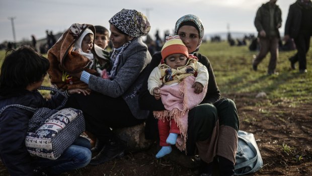 Syrian Kurdish women with their children near the Turkish-Syrian border at Suruc.