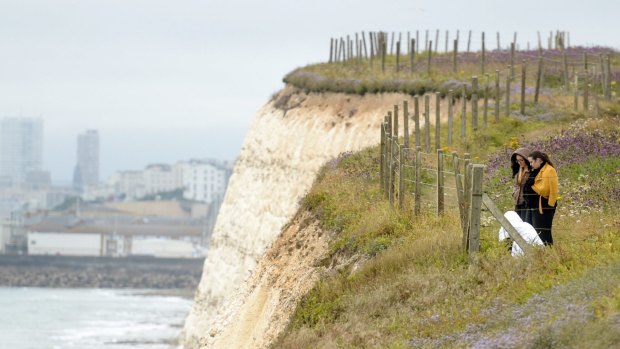 People lay flowers at the clifftop where Arthur Cave fell to his death.