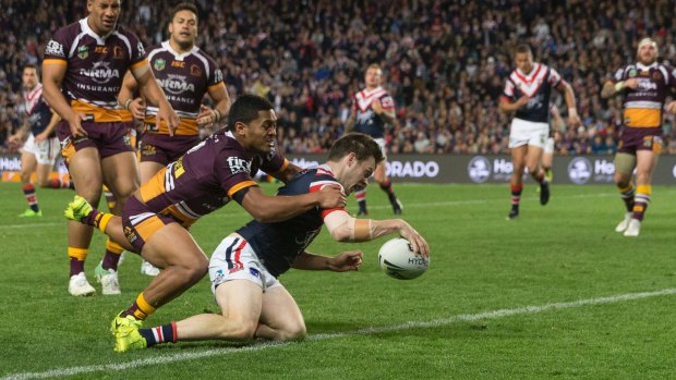 Grounded: Luke Keary beats the tackle of Anthony Milford to score.