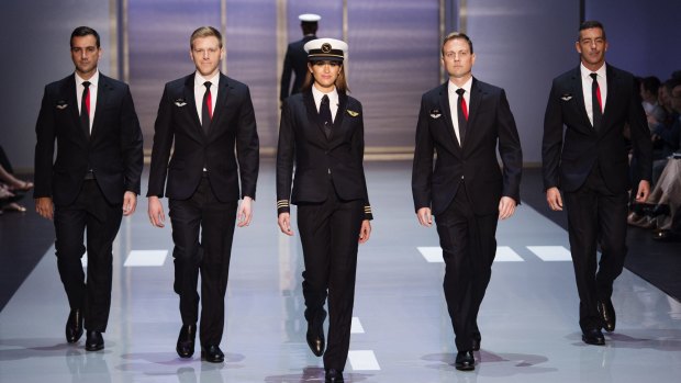 Qantas unveiled its new pilot uniforms on Friday. The female uniforms - pictured here alongside new male cabin crew outfits - are more tailored than the male look.