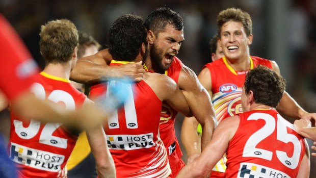 CAIRNS, AUSTRALIA - JULY 14:  Karmichael Hunt (C) of the Suns celebrates with team mates after kicking the match winning goal after the final siren during the round 16 AFL match between the Richmond Tigers and the Gold Coast Suns at Cazaly's Stadium on July 14, 2012 in Cairns, Australia.  (Photo by Matt King/Getty Images)