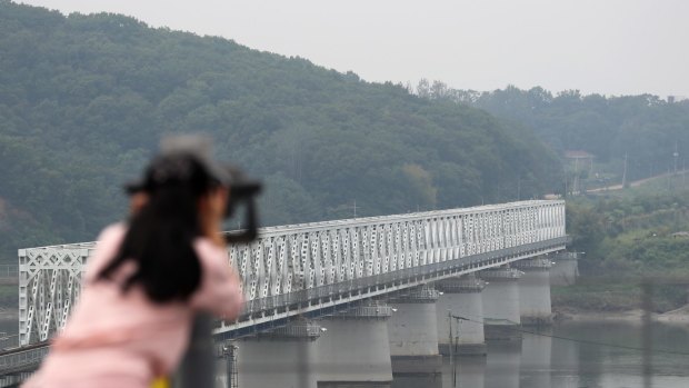 A visitor uses binoculars to look across to the north side of the border at the Imjingak pavilion near the Demilitarized Zone (DMZ) in Paju, South Korea.