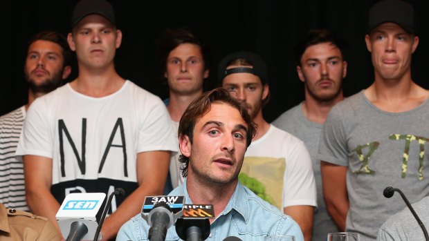 Flanked by his temmates, Essendon captain Jobe Watson speaks to the media on Tuesday.