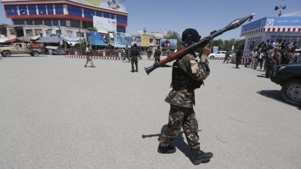 Afghan security forces patrol streets in Kunduz as the death toll from the war with the Taliban grows. 