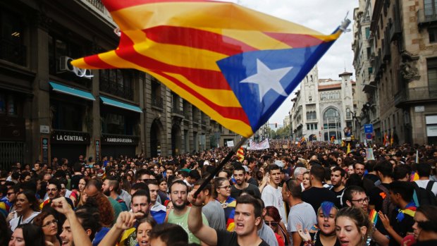 Supporters fly Catalonia's independent flag as Spain plunges into its worst political crisis since an attempted military coup in 1981.