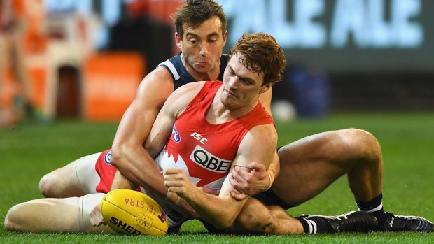 Courageous: Gary Rohan is tackled during the preliminary final.