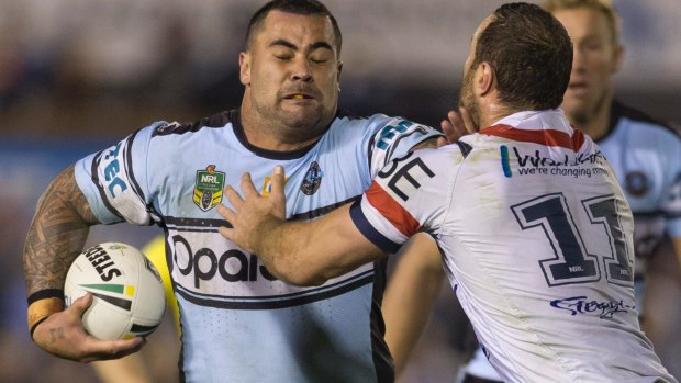 Shark Andrew Fifita is tackled by Boyd Cordner of the Roosters.