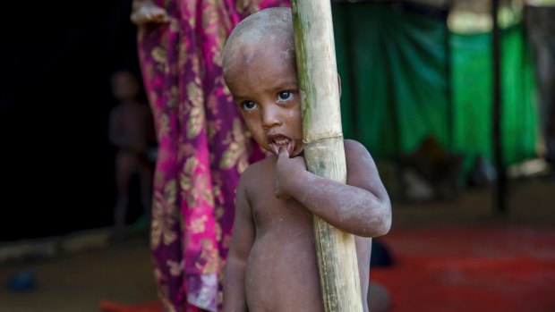 A Rohingya Muslim boy, who crossed over from Myanmar into Bangladesh, stands near a newly built shelter at Balukhali.