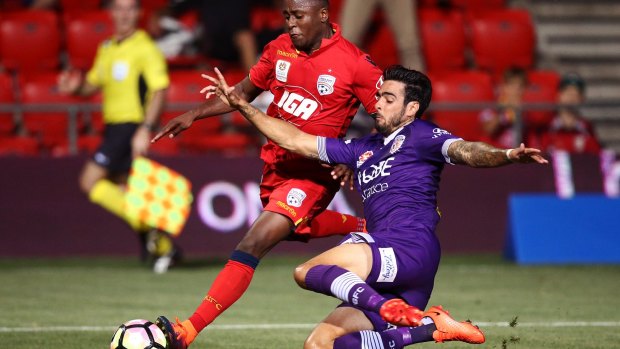 GOing in hard: Rhys Williams of Perth Glory tackles Mark Ochieng of Adelaide United in round 19.
