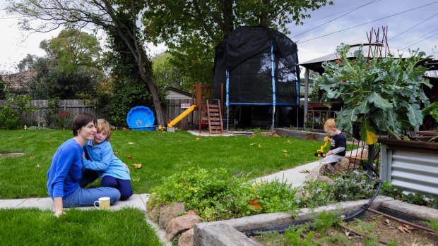 Suzanne Pippen with her children Hannah, 4, and Dominic, 2, in their Duffy back yard, worried about being built out by dual occupancies that will be allowed on Fluffy blocks.