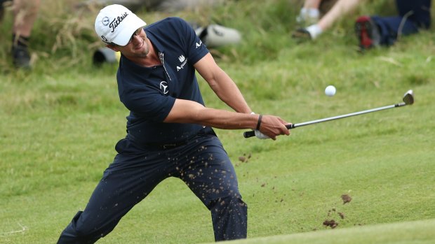 Adam Scott plays a bunker shot on the 15th hole during the final round of the 2012 British Open