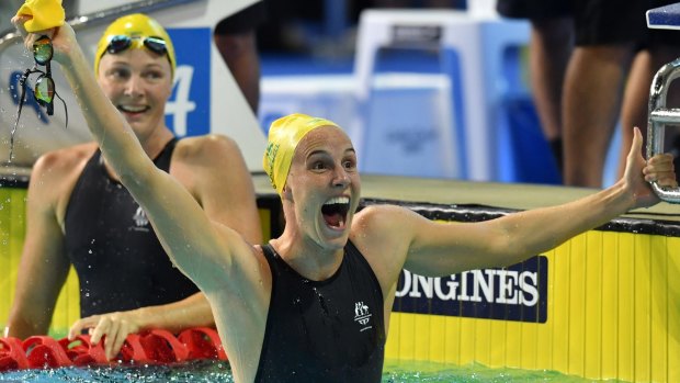 Sister act: Bronte Campbell reacts to winning the 100m freestyle as Cate looks on.