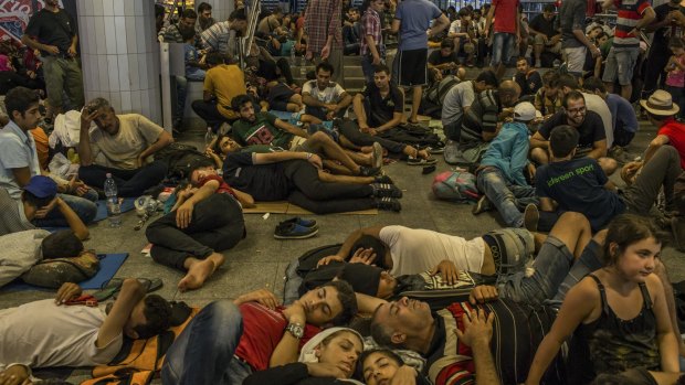 Migrant families sleep underneath the Keleti train station in Budapest on Wednesday.