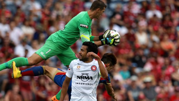 Western Sydney Wanderers goalkeeper Ante Covic gets to the ball ahead of Kije Lee of the Jets (partly hidden) as Nikolai Topor-Stanley of the Wanderers tries to get out of the way during a match in Newcastle on February 14. Both teams have no chance of making the finals this year.