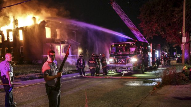 According to eyewitness, protesters demonstrating against the police shooting earlier in the day in St Louis set the building on fire on Wednesday.